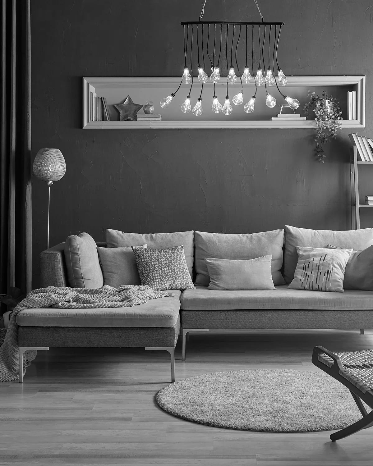 Open-plan living space with full-height windows and exposed structure